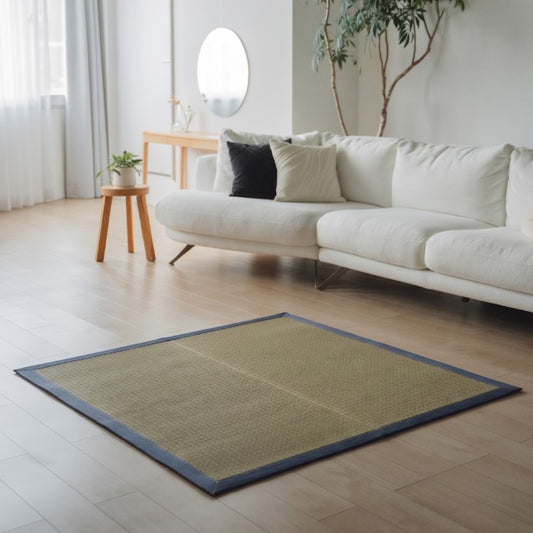 Square Japanese Tatami Area Rug "MUKU" Denim on a wooden floor, adding a modern indigo accent to a minimalist living room.