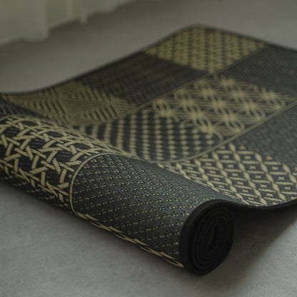 Japanese Tatami Yoga Mattress "Ed Plain" Black partially rolled, displaying the traditional Edo Komon woven pattern.