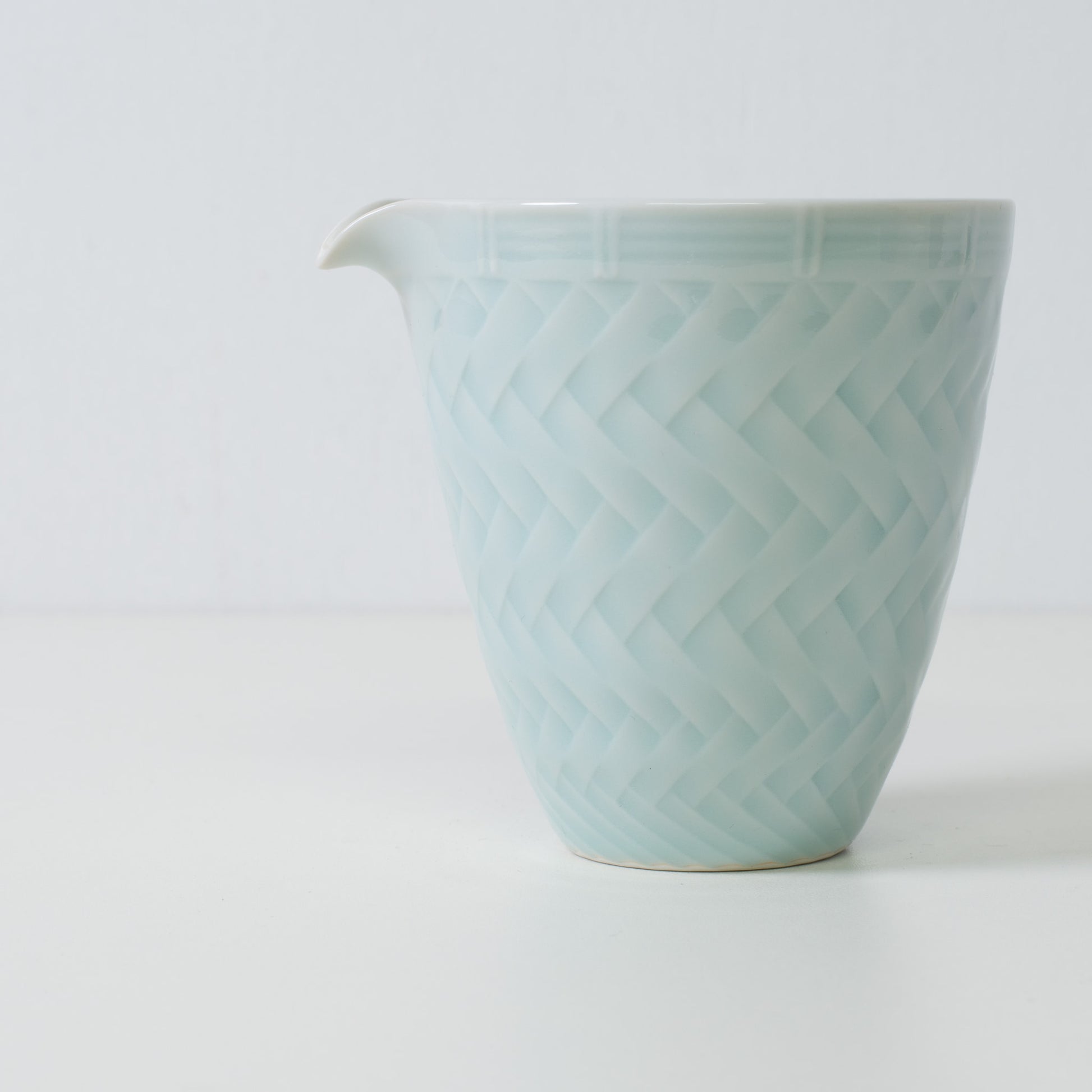 Basket weave sake carafe, ice blue, porcelain - Close up of a Japanese sake carafe showing the woven pattern
