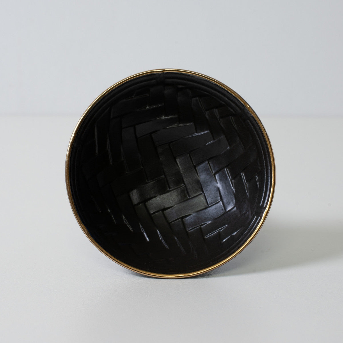 Basket weave sake cup, black porcelain - Top down view of a sake cup revealing inner texture and gold rim