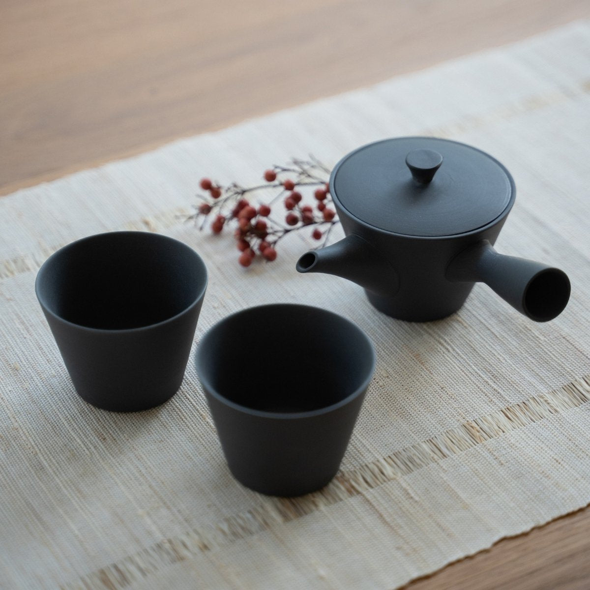 Black Japanese tea set "Sencha" on a linen mat for minimalists enjoying a calm daily tea ritual.