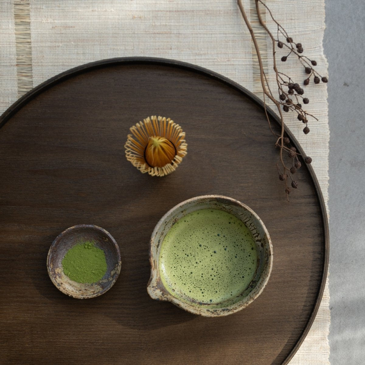 Japanese matcha bowl with spout on a wooden tray for a calm tea ritual with whisked green tea.