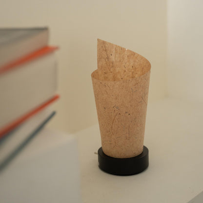 Close-up of an unlit Japanese paper table lamp "Maki" Cedar Bark showcasing its rolled design and natural paper texture for wabi sabi decor.