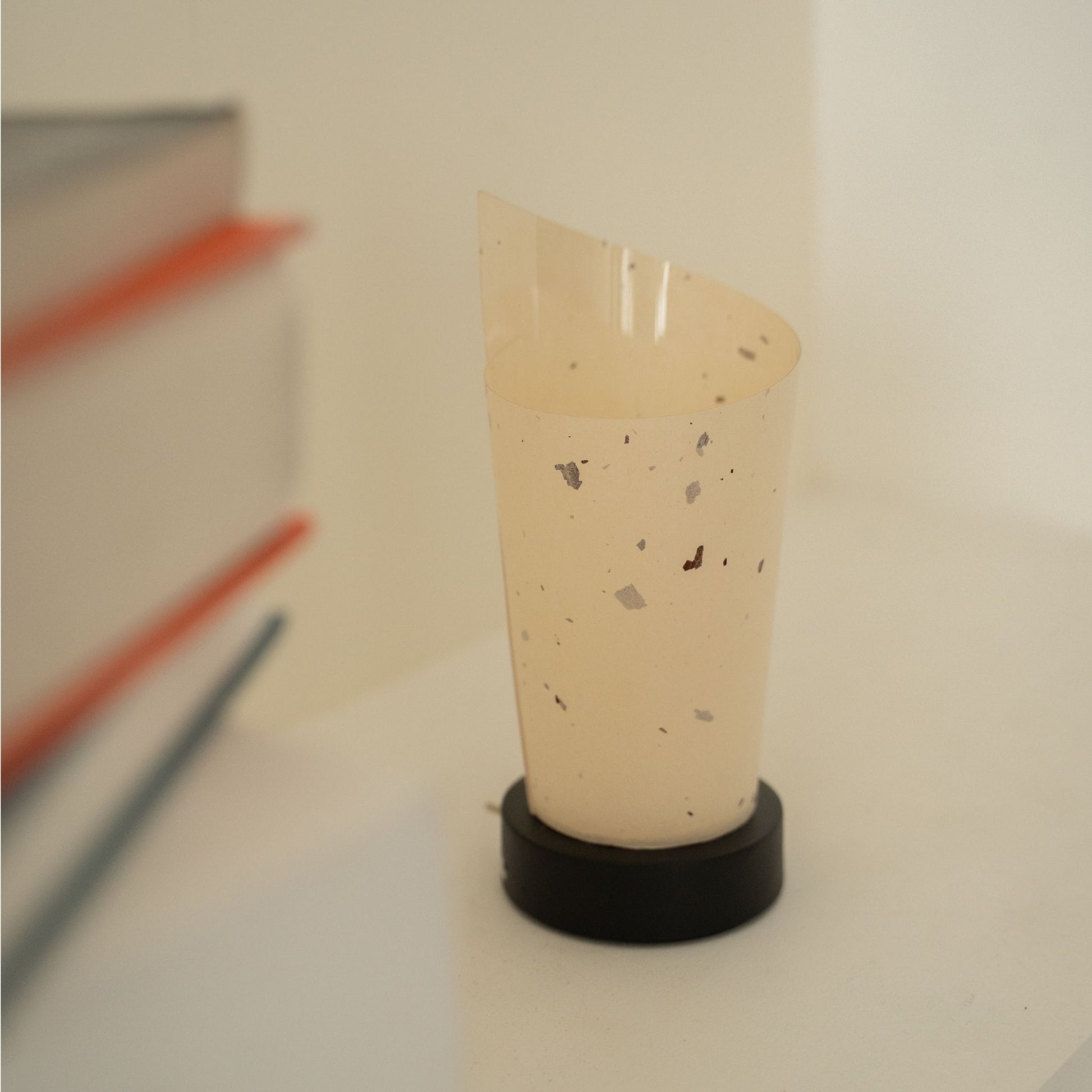 Close-up of an unlit Japanese paper table lamp "Maki" showcasing its rolled design and natural paper texture for wabi sabi decor.