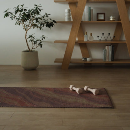 Japanese Tatami Yoga Mattress "Marble" Pink with dumbbells on a wooden floor in a stylish Japandi room for daily practice.