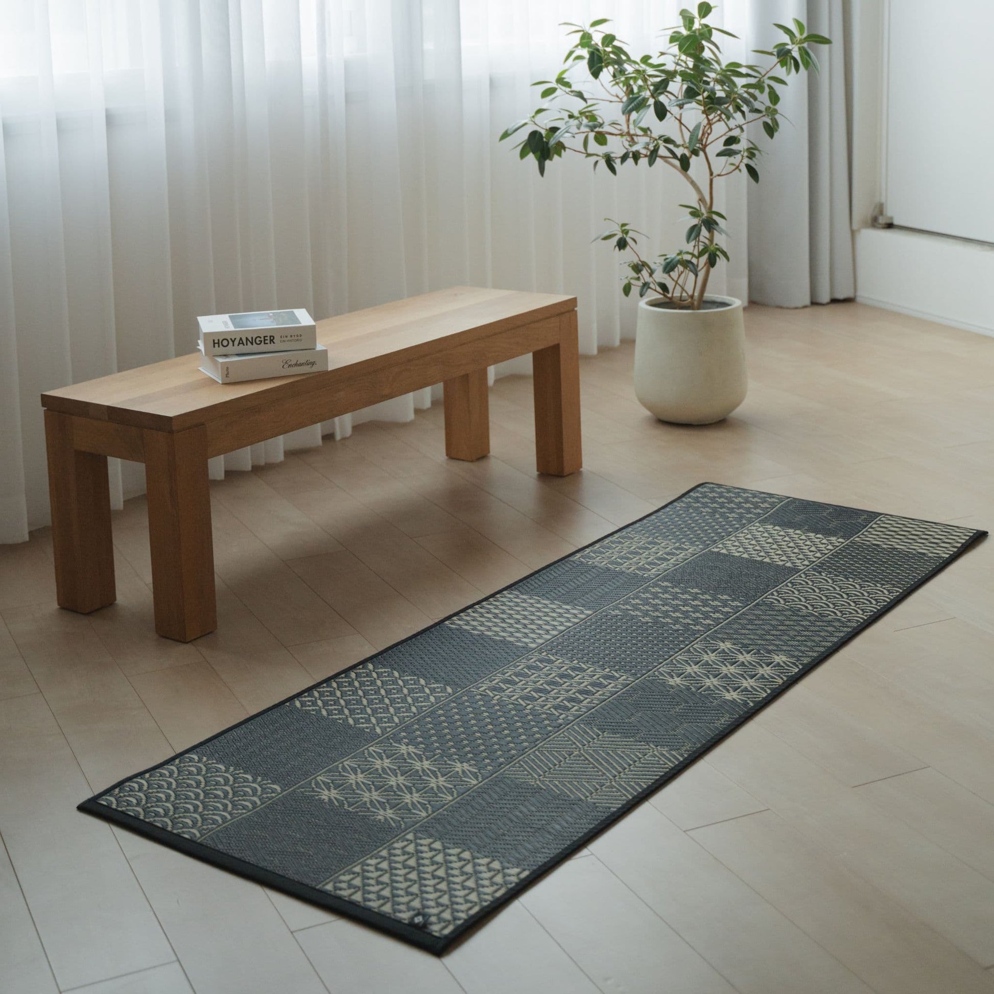 Japanese Tatami Yoga Mattress "Ed Plain" Black in a modern living room, creating a serene space for mindful meditation.