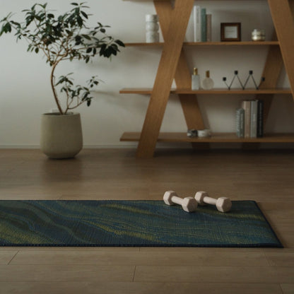 Japanese Tatami Yoga Mattress "Marble" Blue with dumbbells on a wooden floor in a stylish Japandi-style mindful space.