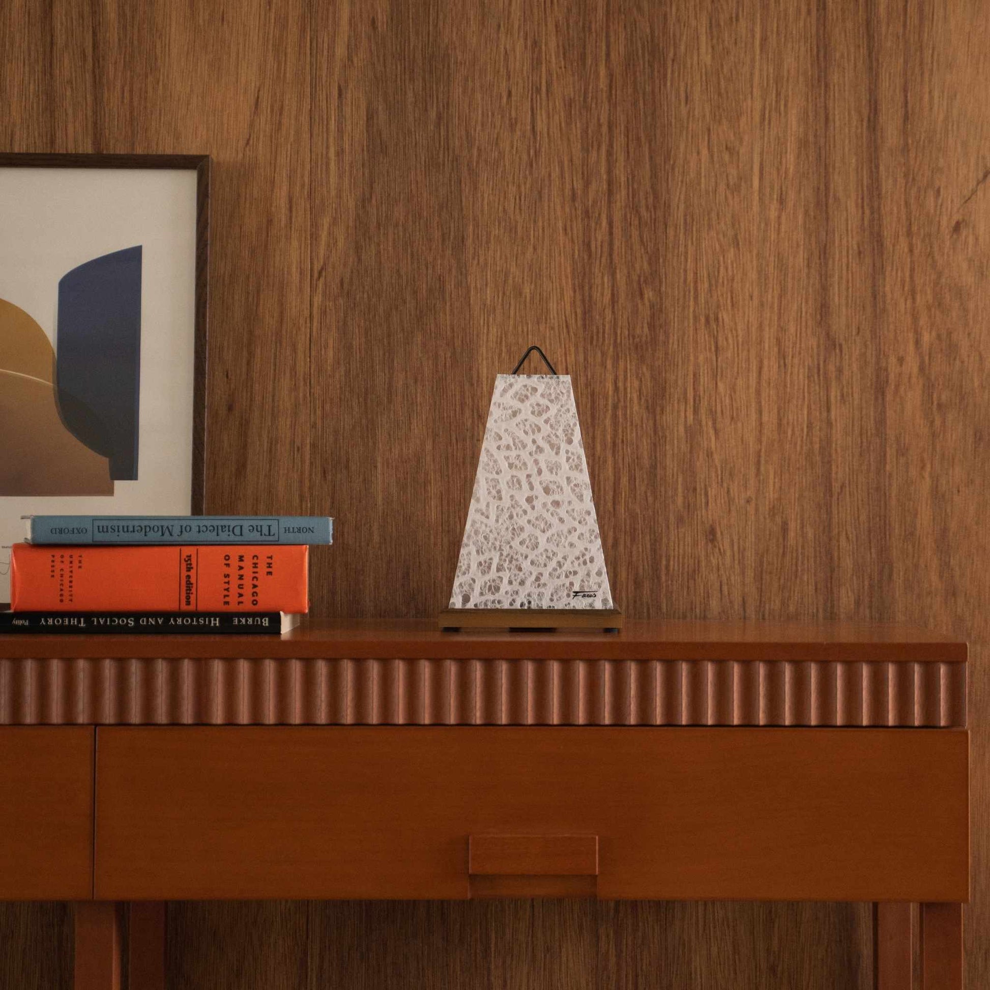 Unlit Japanese paper table lamp Mini Akari White styled on a mid-century modern wooden console table with books.