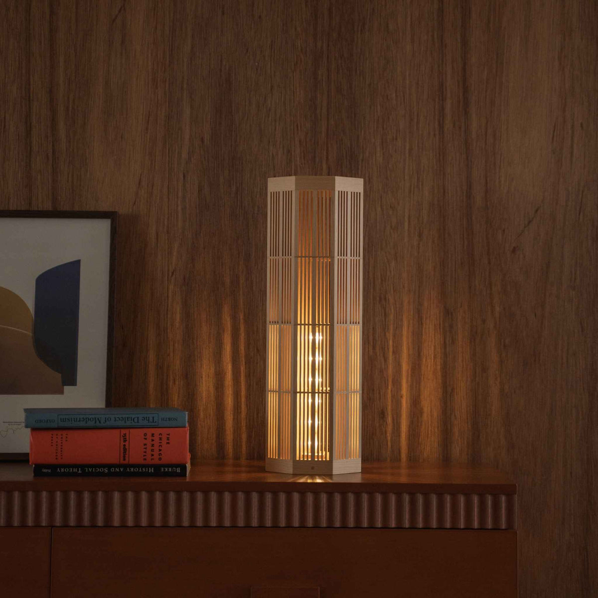 Glowing Japanese floor lamp "SAN" Large featuring Kumiko woodworking on a mid-century modern living room console.