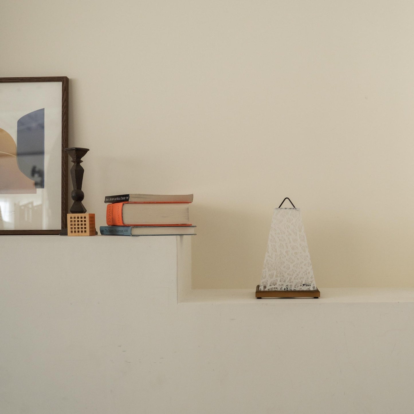 Unlit Japanese paper table lamp "Mini Akari" White placed on a white console table in a minimalist Japandi living room.