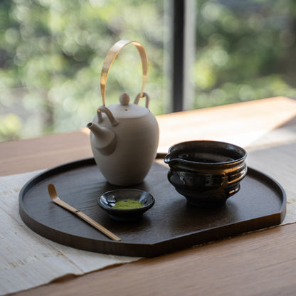 Dignity Blue matcha bowl with spout and teapot on a tray by a window, perfect for authentic whisking or casual lattes