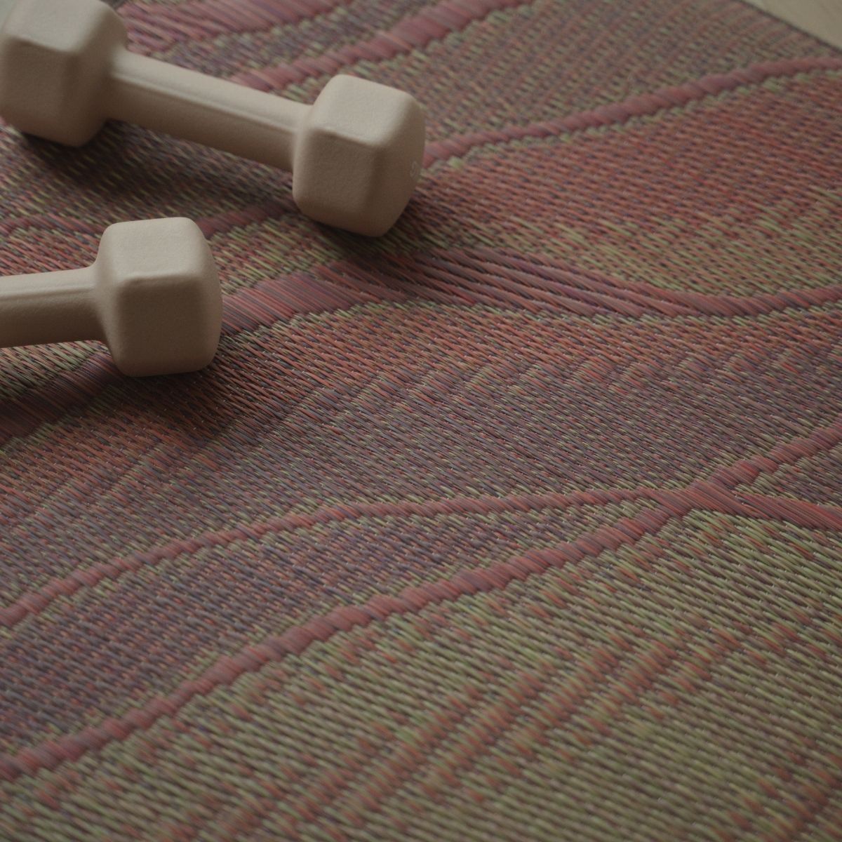 Detailed weave of the Japanese Tatami Yoga Mattress "Marble" Pink with small dumbbells, showing authentic tatami texture.