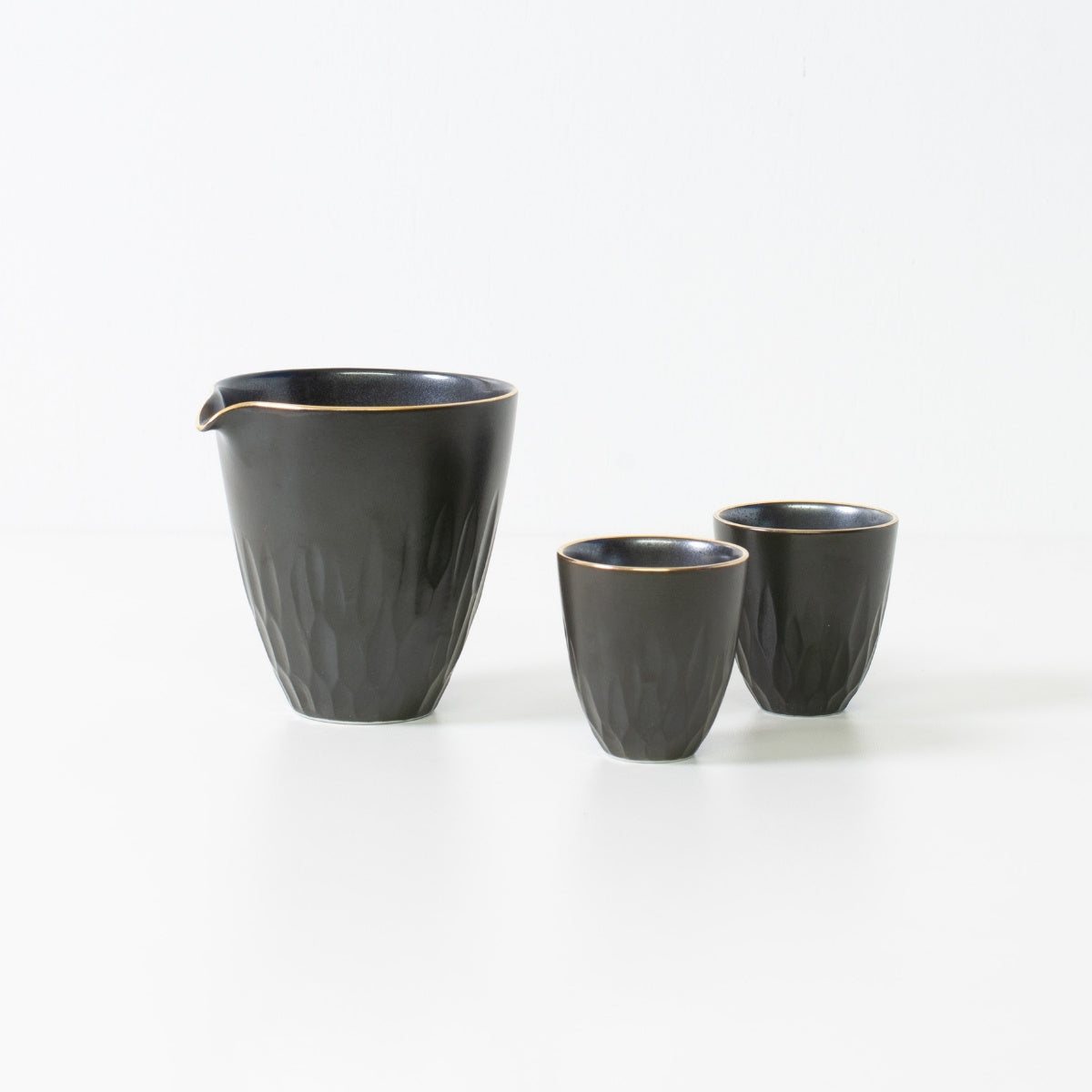 Floral carved sake set, black porcelain - Traditional wabi-sabi Japanese sake set featuring a carafe and two cups