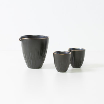 Floral carved sake set, black porcelain - Traditional wabi-sabi Japanese sake set featuring a carafe and two cups