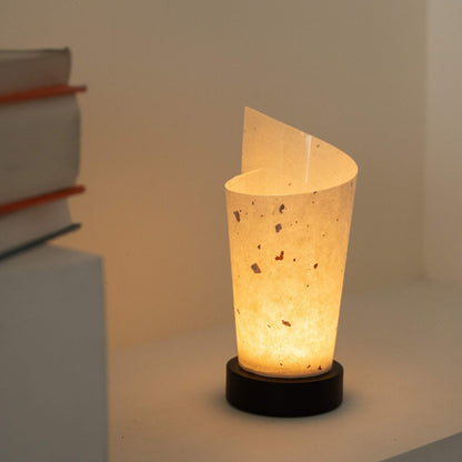 Glowing Japanese paper table lamp "Maki" revealing rustic paper details and providing a soft glow as a cozy accent lamp.