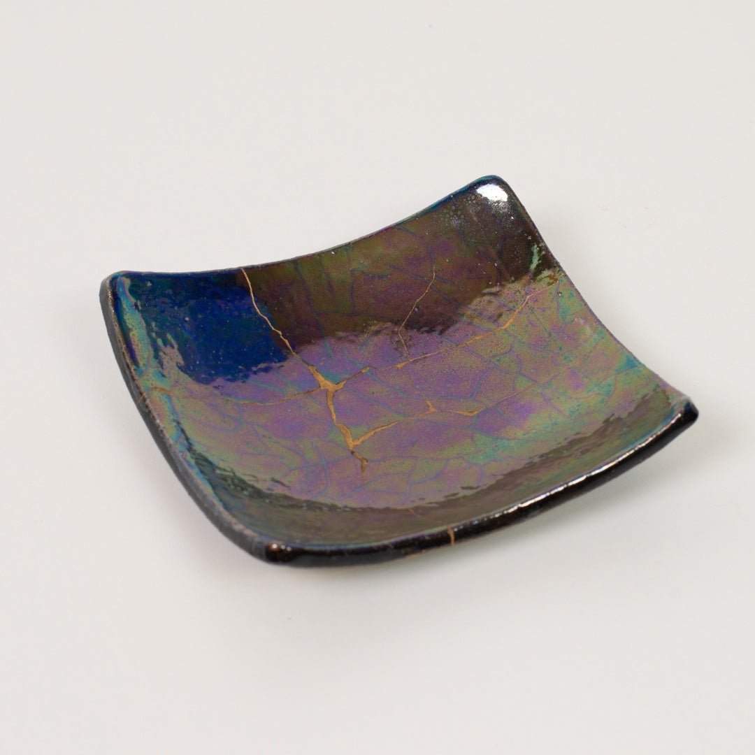 Close-up of iridescent luster kintsugi art plate 01, meaningful gift symbolizing resilience and wabi sabi design.
