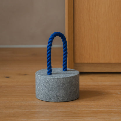 Japanese Aji Stone Doorstop "FUJ" in natural stone styled in a interior space, interior scene view.