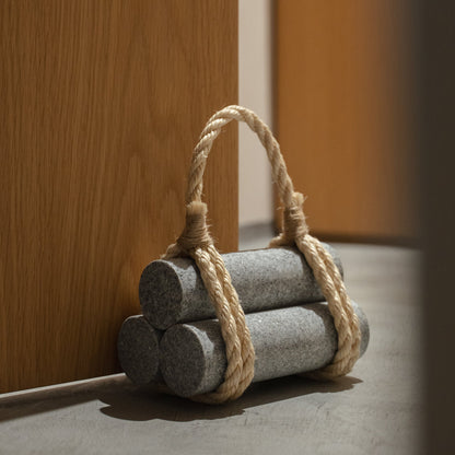 Japanese Aji Stone Doorstop "komame" in natural stone styled in a entryway setting, entryway scene view.