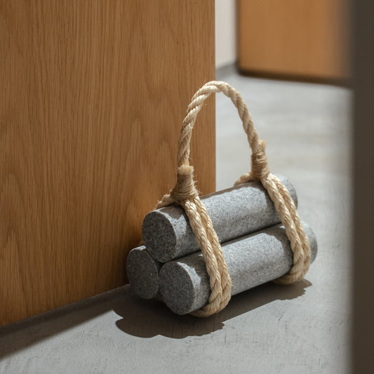 Japanese Aji Stone Doorstop "komame" in natural stone styled in a entryway setting, entryway scene view.