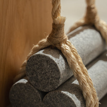 Japanese Aji Stone Doorstop "komame" in natural stone styled in a styled room, detail lifestyle view.