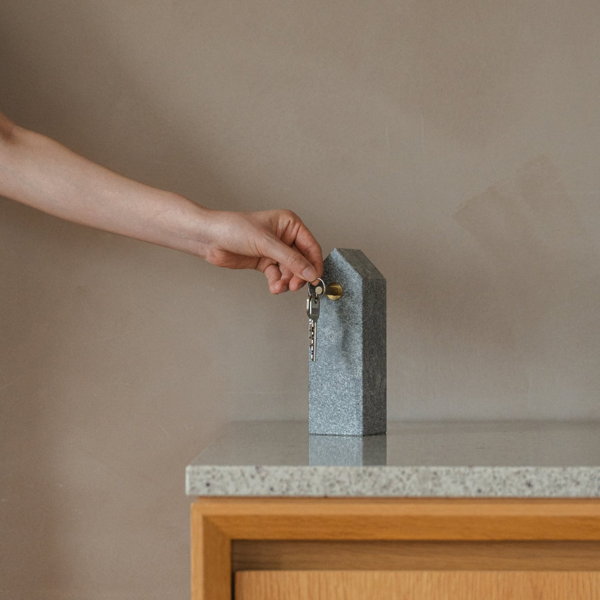 Japanese Aji Stone Key Holder in natural stone styled in a entryway setting, entryway scene view.