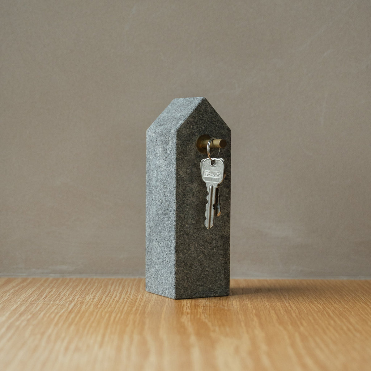 Japanese Aji Stone Key Holder in natural stone styled in a interior space, interior scene view.