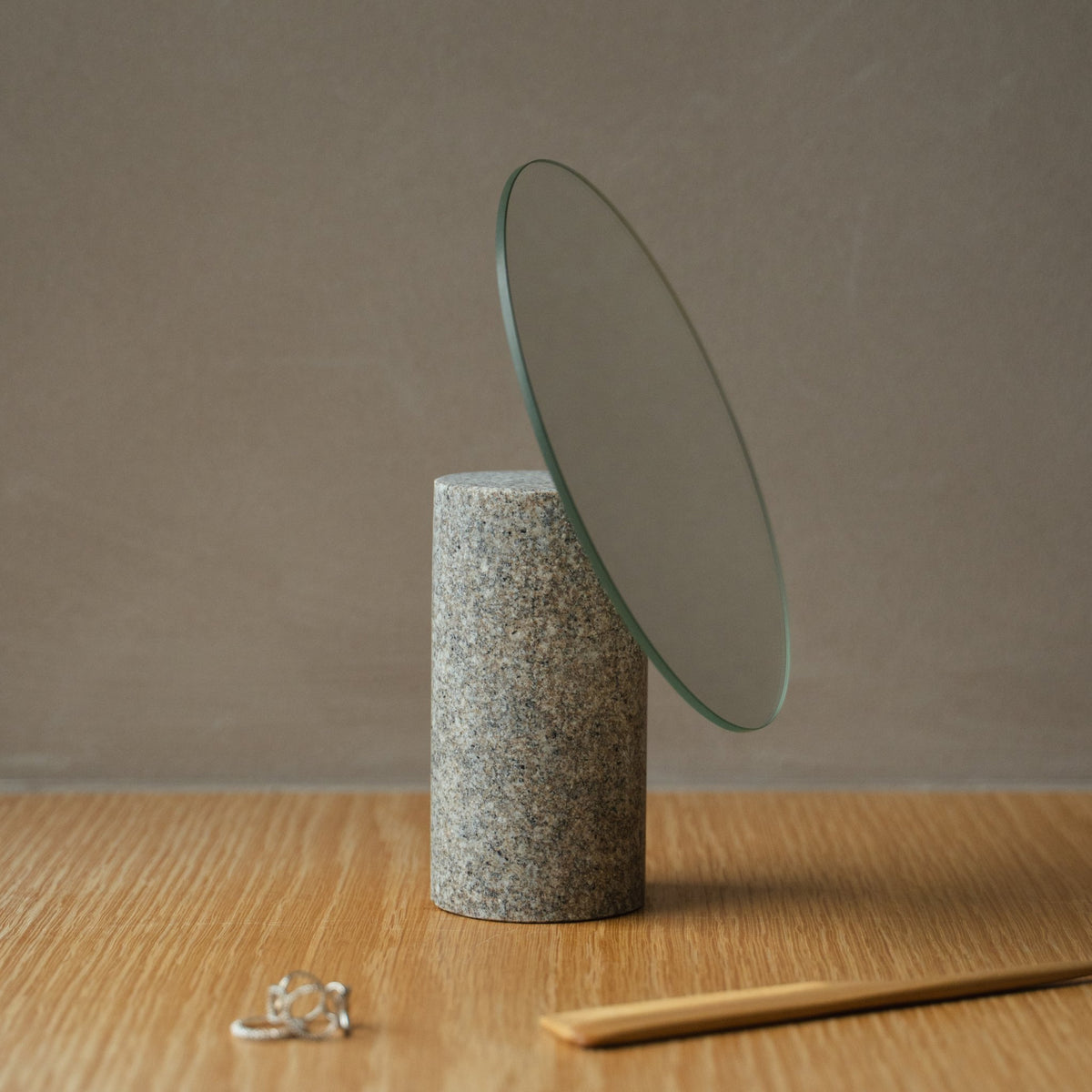 Japanese Aji Stone Table Mirror in natural stone styled in a console table setting, console scene view.