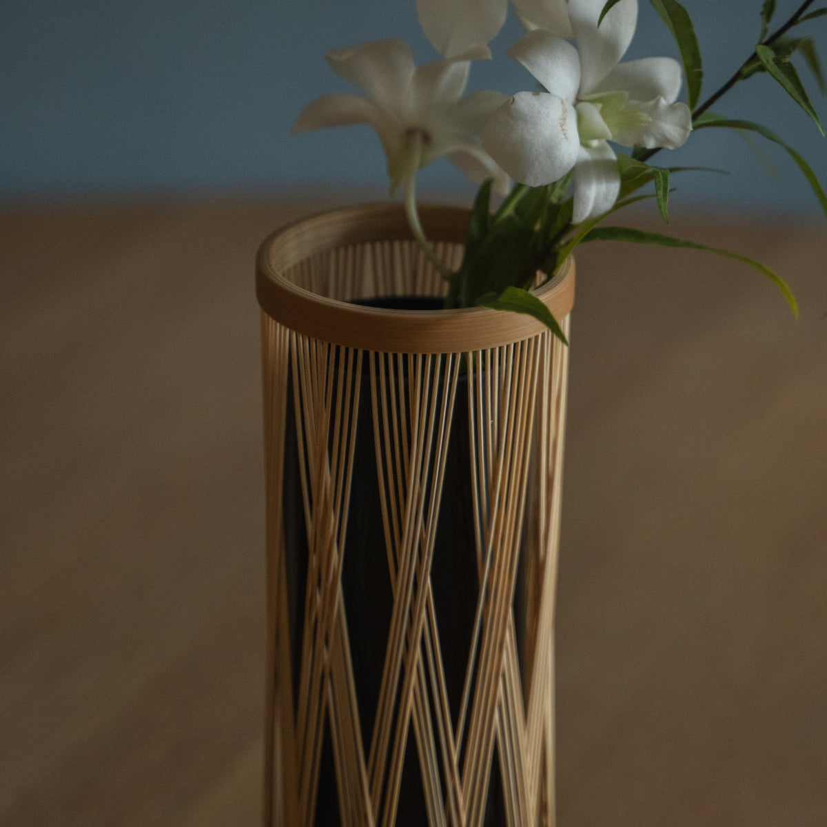 Japanese Bamboo Flower Vase "Entwined Branch" in brown styled in a interior space, interior scene view.