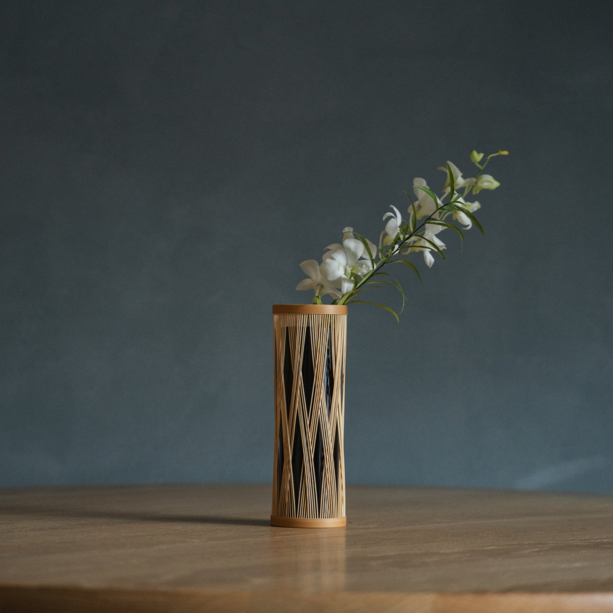 Japanese Bamboo Flower Vase "Entwined Branch" in brown styled in a interior space, interior scene view.