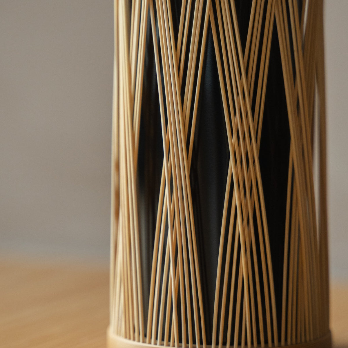 Japanese Bamboo Flower Vase "Entwined Branch" in brown styled in a styled room, detail lifestyle view.
