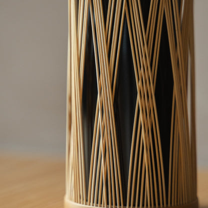 Japanese Bamboo Flower Vase "Entwined Branch" in brown styled in a styled room, detail lifestyle view.