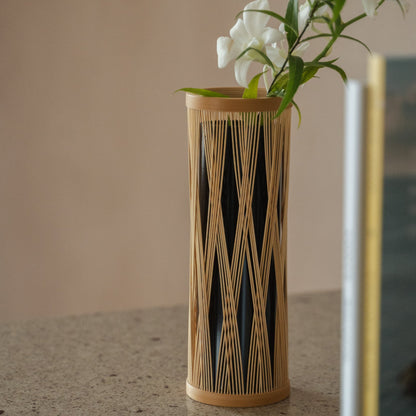 Japanese Bamboo Flower Vase "Entwined Branch" in brown styled in a styled room, detail lifestyle view.