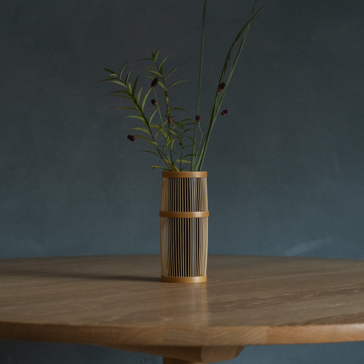 Japanese Bamboo Flower Vase "Shiori" in brown styled in a dining room setting, dining scene view.