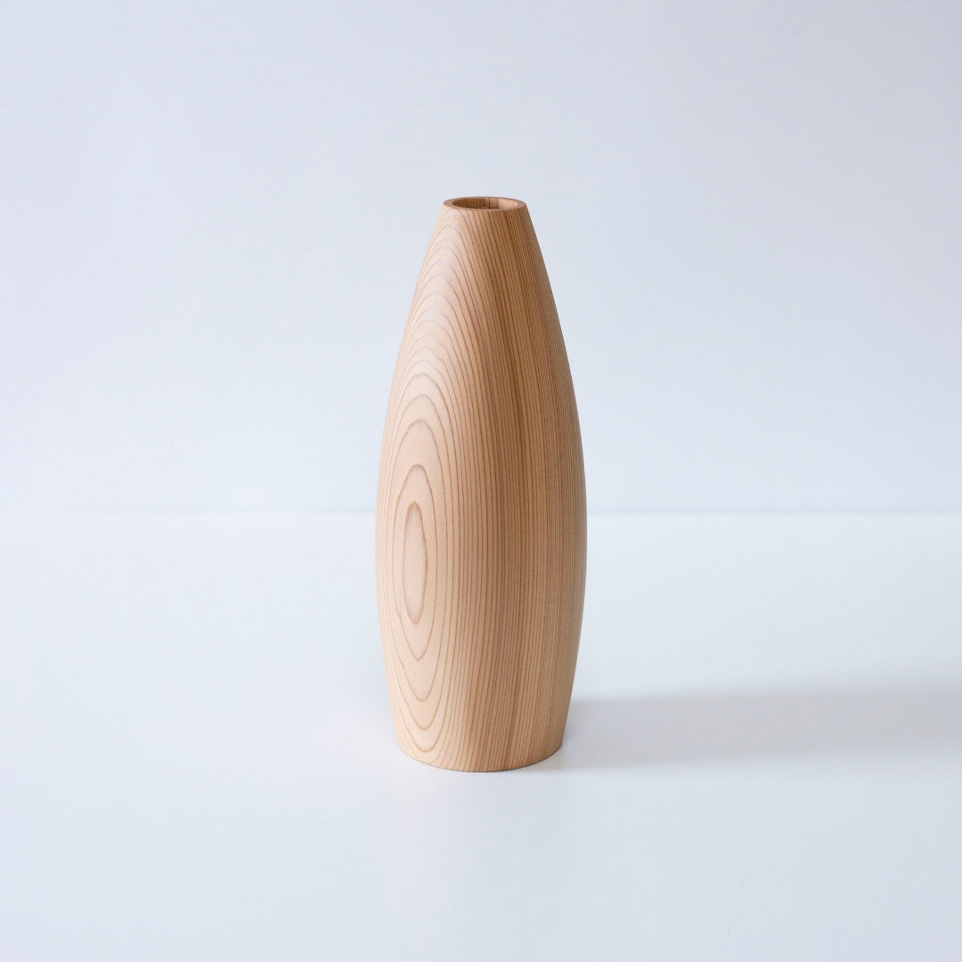 A minimalist cedar wood Ikebana vase showcasing the natural beauty of the wood grain.