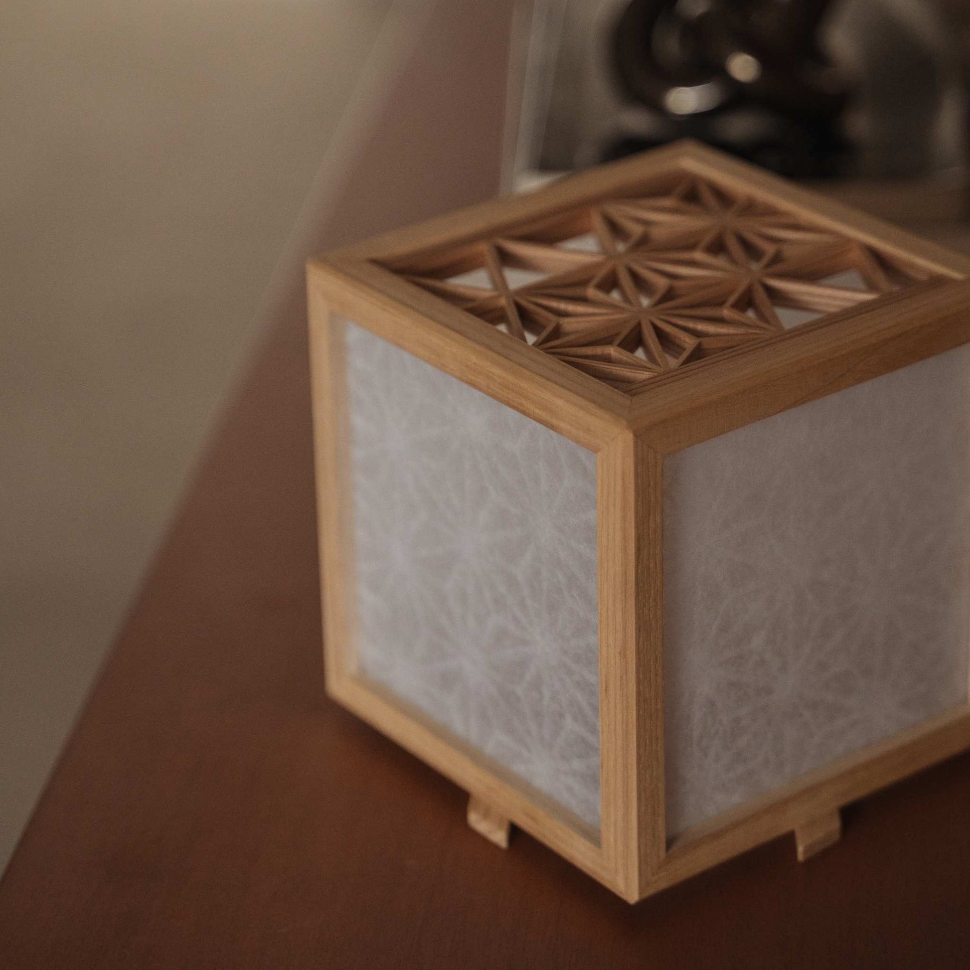 High angle view of a handcrafted japanese kumiko lantern cover made of akita cedar showing intricate geometric joinery.