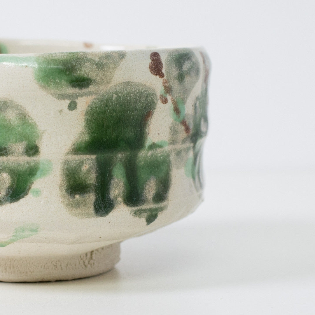 Close-up detail of "Forest" matcha chawan bowl showing the textured Shino clay surface and moss-like green glaze patterns typical of Mino ware.