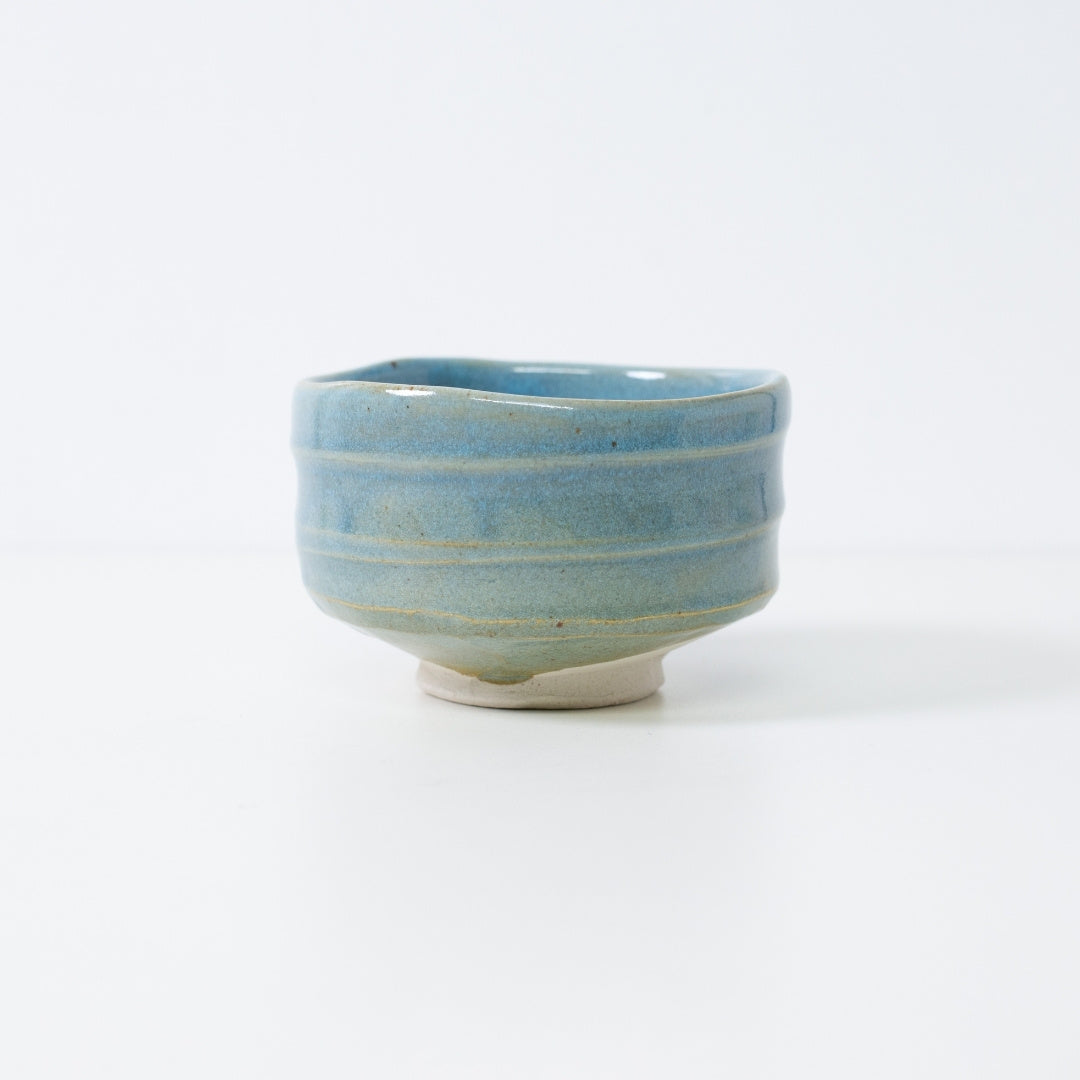 Handcrafted Japanese matcha bowl "Summer Sky" by Shinzan Kiln, featuring a vibrant blue glaze over textured Shino clay.