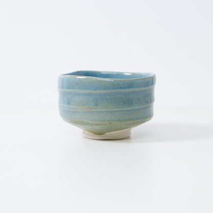 Handcrafted Japanese matcha bowl "Summer Sky" by Shinzan Kiln, featuring a vibrant blue glaze over textured Shino clay.