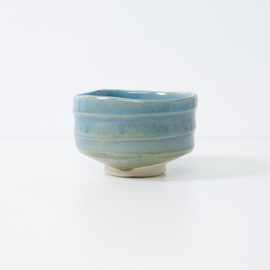 Handcrafted Japanese matcha bowl "Summer Sky" by Shinzan Kiln, featuring a vibrant blue glaze over textured Shino clay.