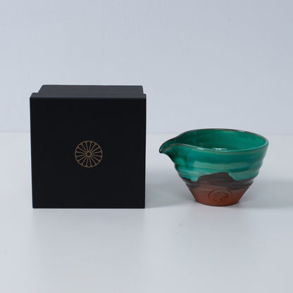 Japanese matcha bowl with spout "Emerald" pottery beside a black gift box with a gold chrysanthemum crest, made in Japan.