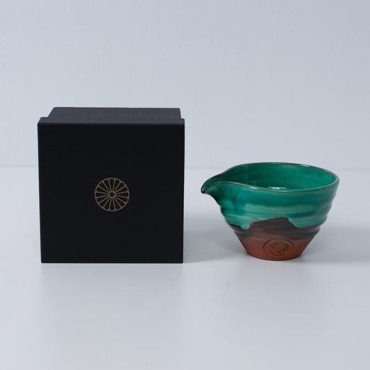 Japanese matcha bowl with spout "Emerald" pottery beside a black gift box with a gold chrysanthemum crest, made in Japan.