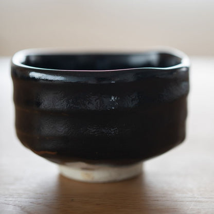 Handcrafted Mino Ware Japanese matcha chawan bowl in Yuzu Black glaze, highlighting the wabi sabi texture.