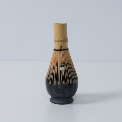 Deep blie Japanese matcha whisk stand "Dignity Blue" pottery chasen stand with a bamboo tea whisk placed on top, made in Japan.