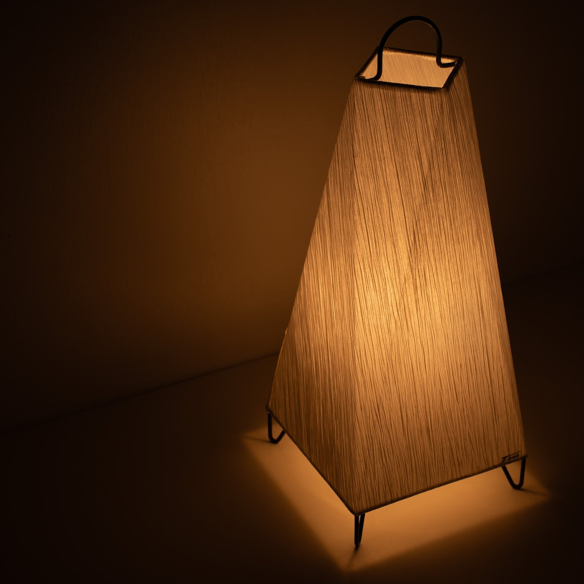 Japanese Paper Floor Lamp ORI Small, white, Mino Washi paper - angled view of illuminated paper lamp on wire legs.