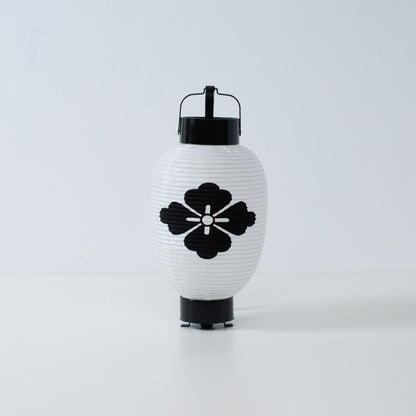 A white Japanese paper lantern featuring a hand-painted black flower diamond hanabishi crest on a white background.