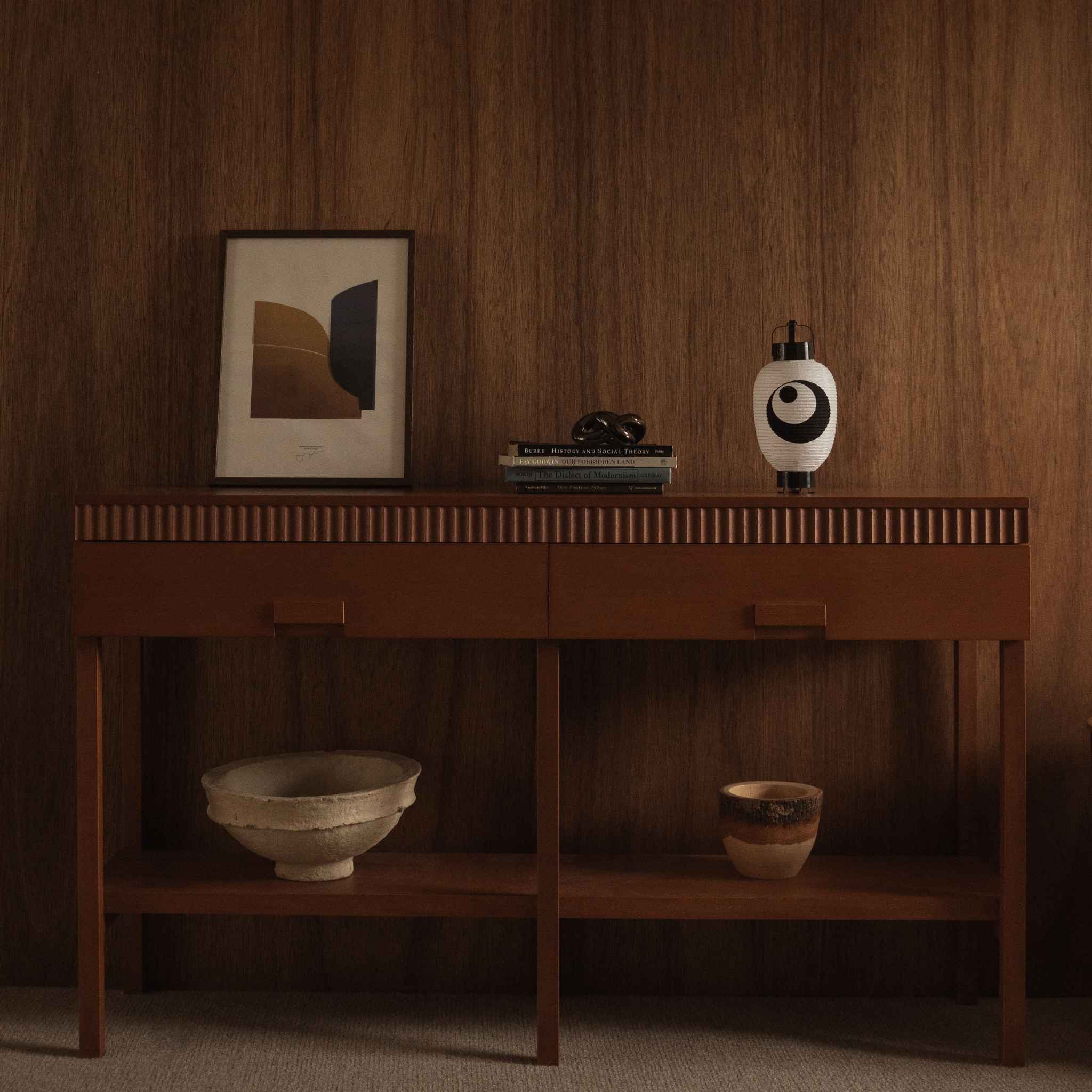 Japanese paper lantern moon and star small standing on a wooden console table in a mid century modern living room