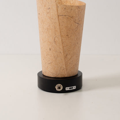 Japanese Paper Table Lamp "Maki" Cedar Bark, brown, wood - close-up of the black base and toggle switch for the cordless lamp.