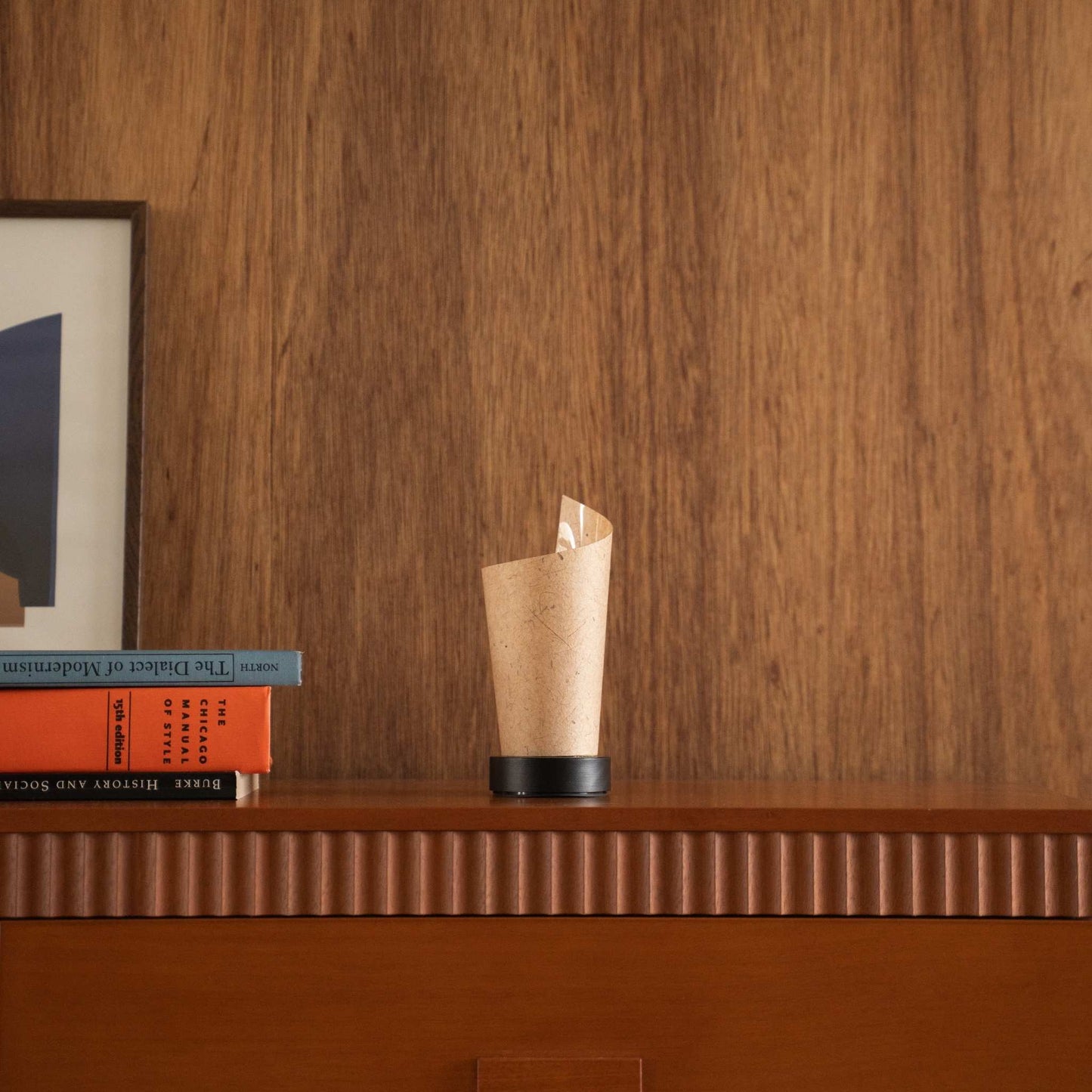 Unlit Japanese paper table lamp "Maki" Cedar Bark with a rolled shape styled on a mid-century modern wooden console table.