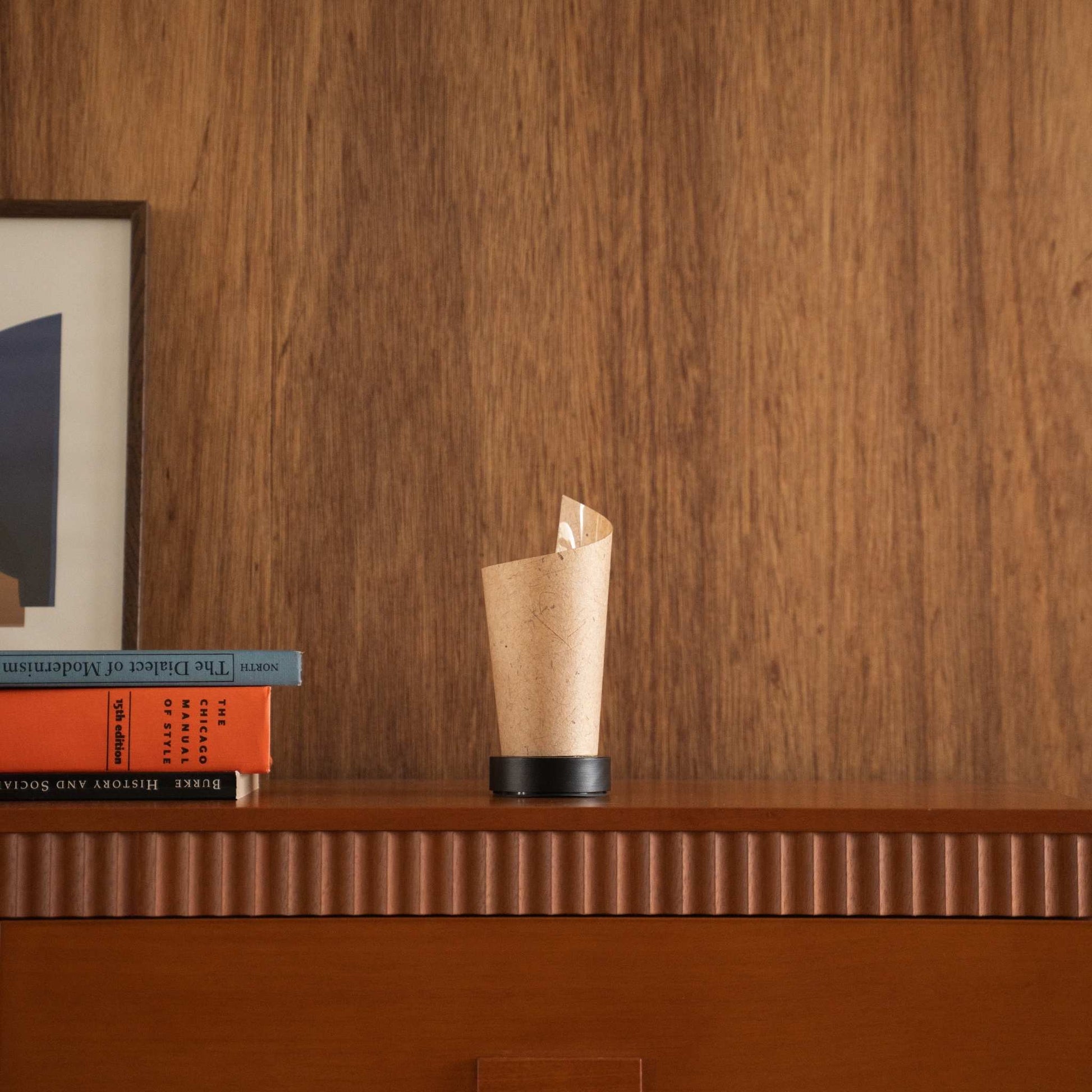 Unlit Japanese paper table lamp "Maki" Cedar Bark with a rolled shape styled on a mid-century modern wooden console table.