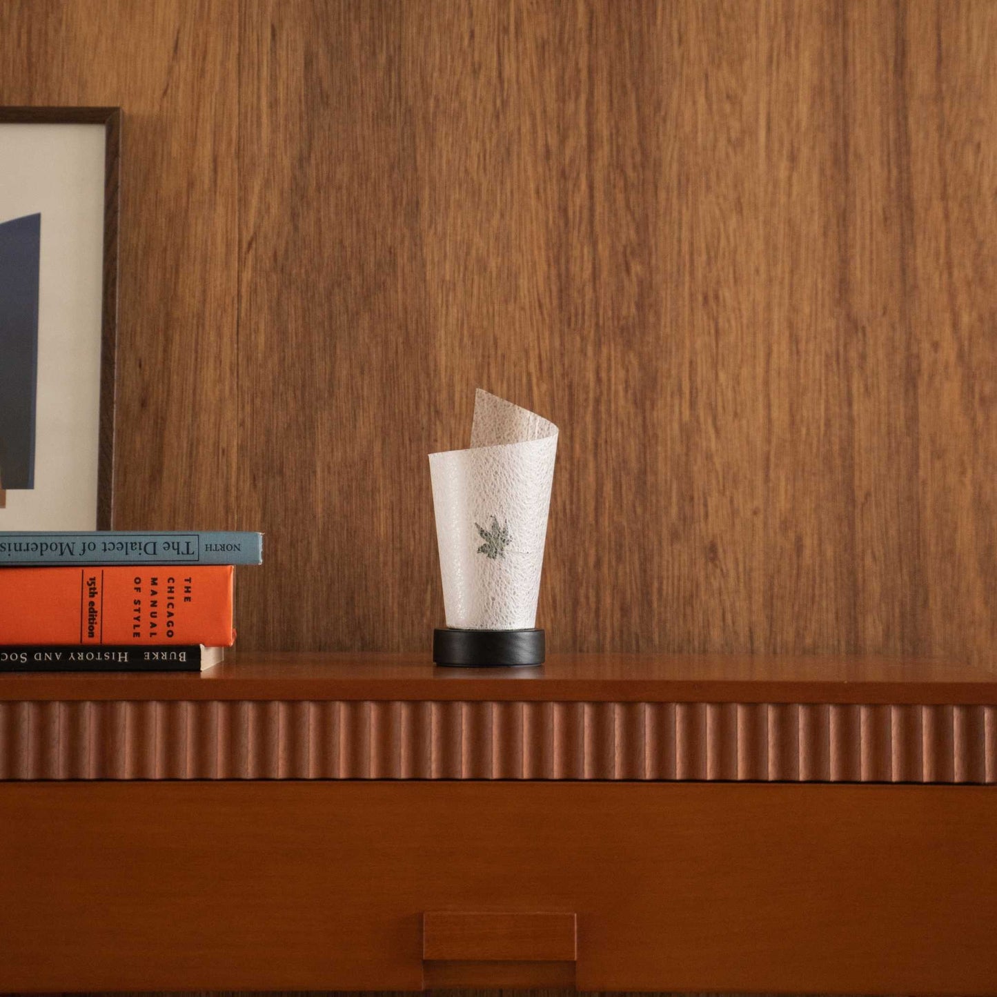 Unlit Japanese paper table lamp "Maki" Momiji Leaf with a rolled shape styled on a mid-century modern wooden console table.
